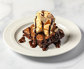 Chocolate brownie topped with vanilla ice cream